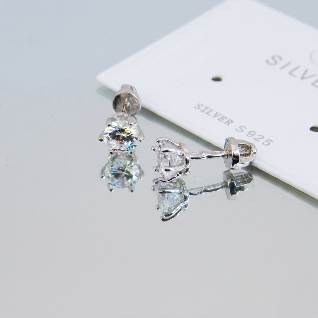 Handgefertigte Silber-Ohrstecker aus 925 Sterling Silber rhodiniert mit funkelndem 5mm Zirkonia und Schraubverschluss auf einer Spiegeloberfläche.